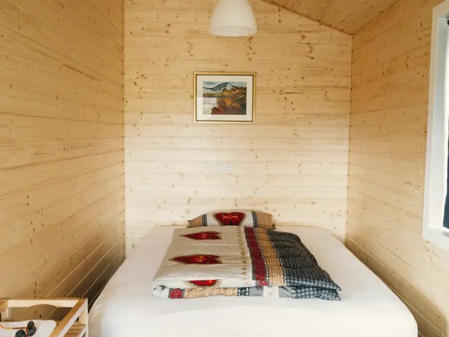 A small wooden cabin bedroom