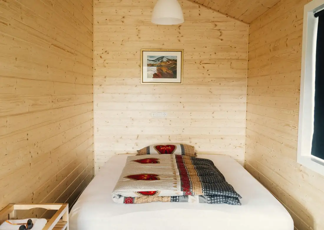 A small wooden cabin bedroom
