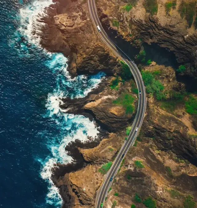 Aerial view of a road winding along a rocky coast