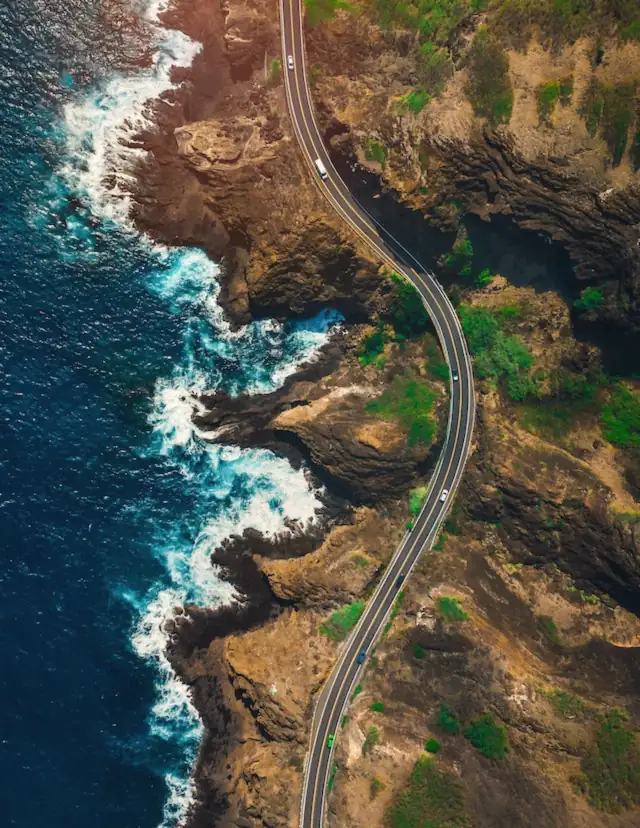 Aerial view of a road winding along a rocky coast