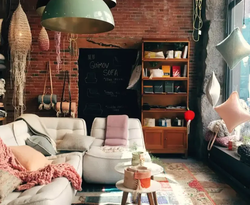 A cosy living room with rugs, lamps and cushions
