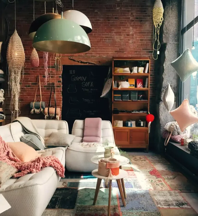 A cosy living room with rugs, lamps and cushions