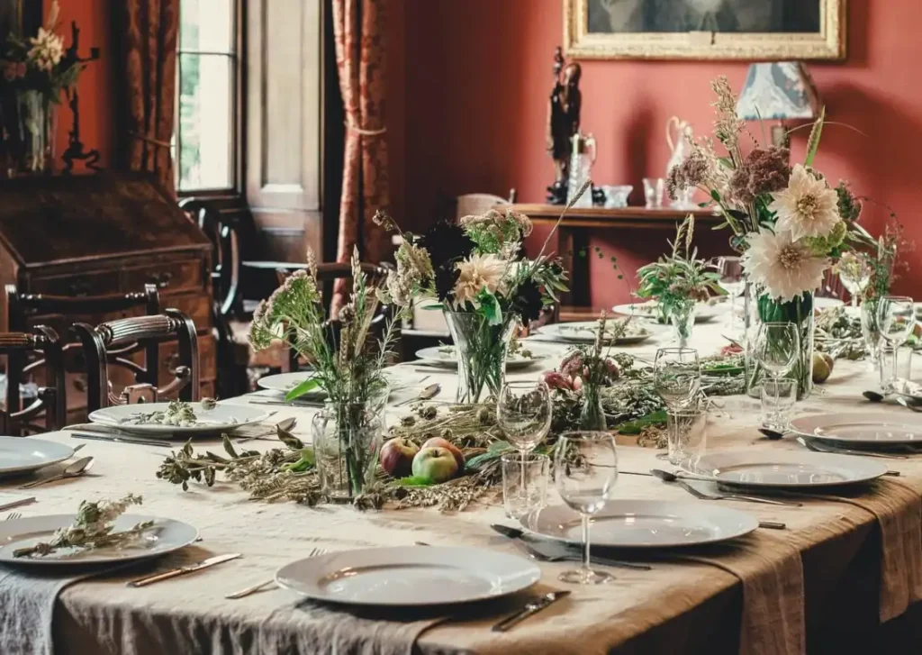 A long dinner table decorated with flowers