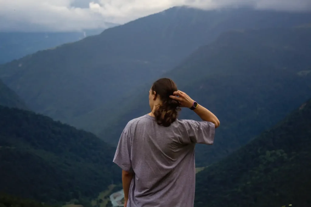 A woman looking out over mountain valleys