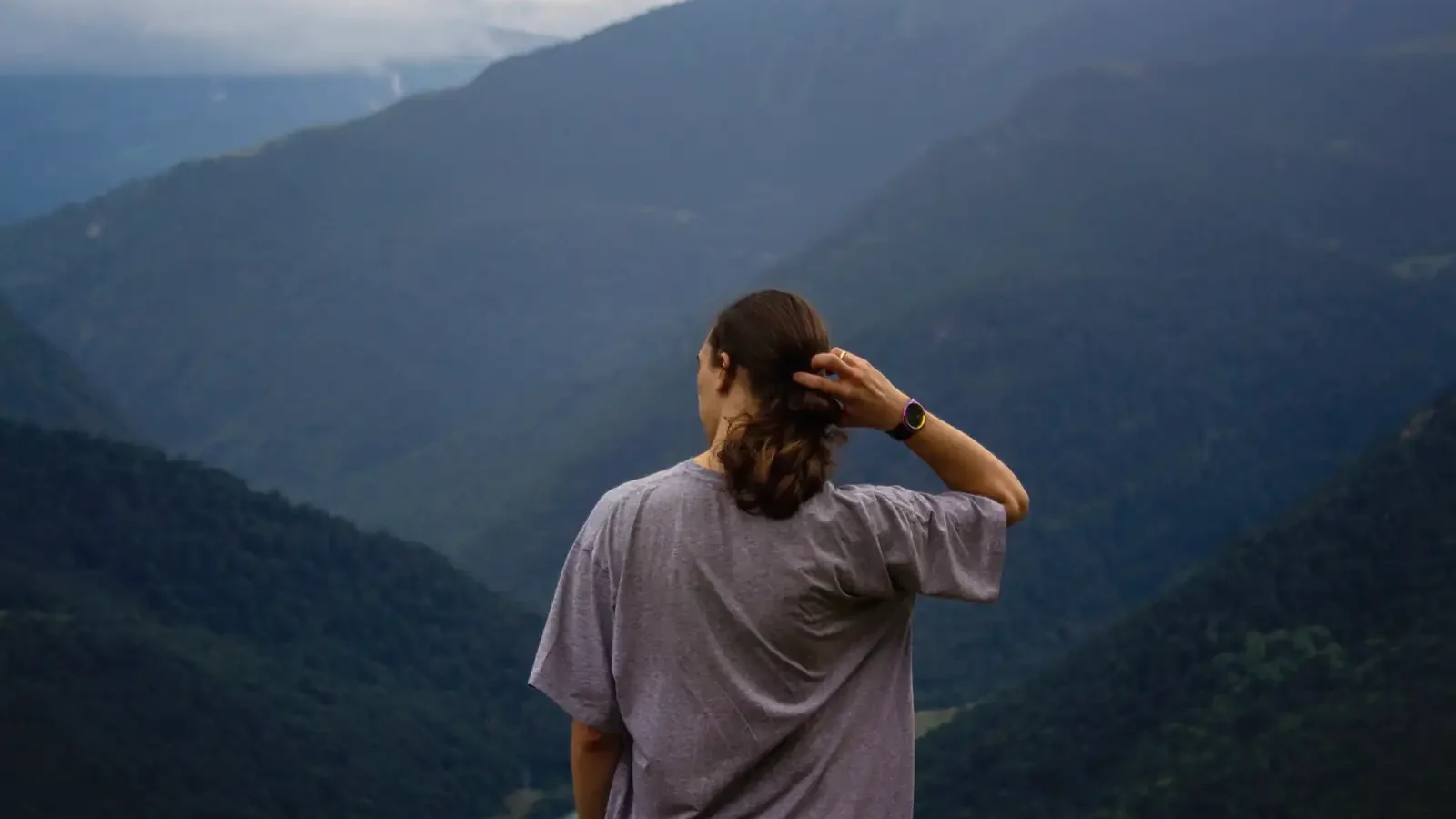 A woman looking out over mountain valleys