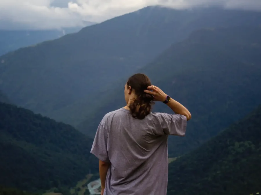 A woman looking out over mountain valleys