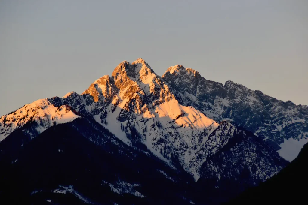 A mountain peak lit by the rising sun