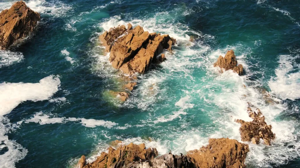 Waves breaking over rocks, seen from above