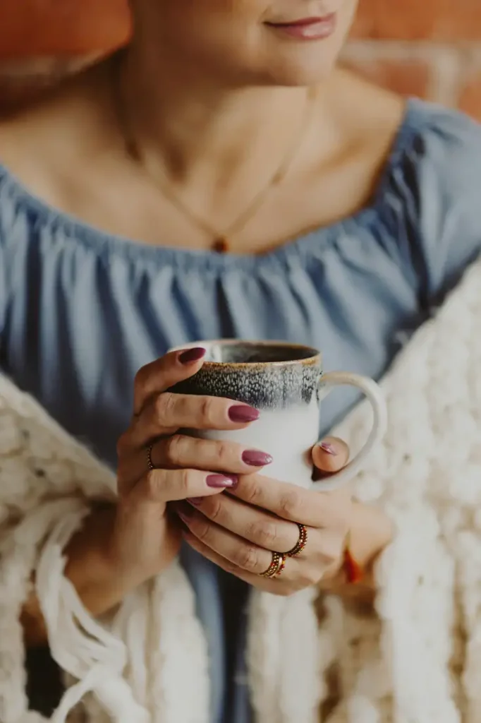 Hands holding a warm cup of coffee