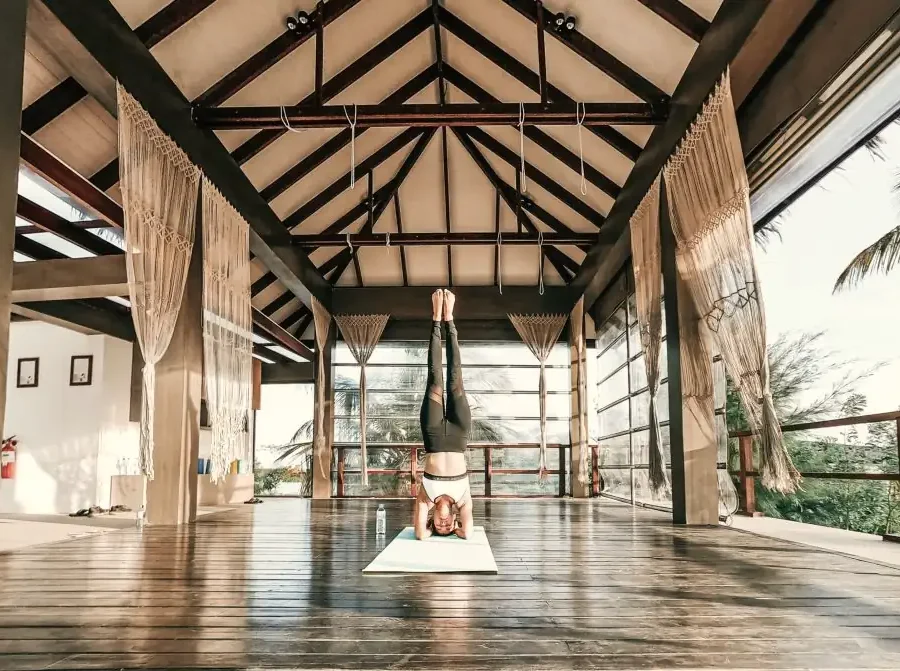 An open wooden pavilion used for yoga
