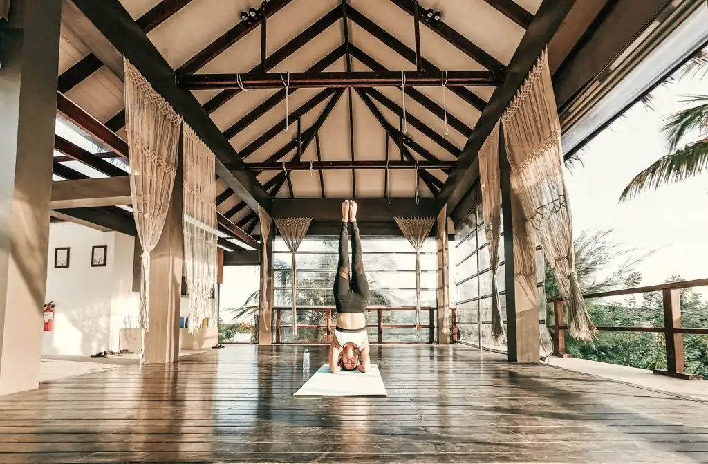 An open wooden pavilion used for yoga